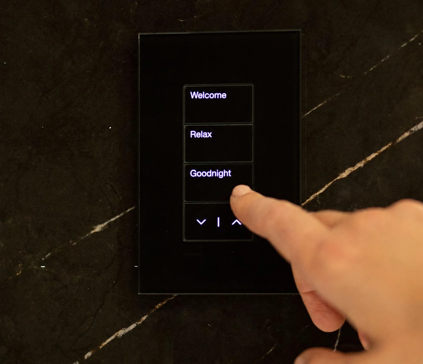 Illustration of a black glass Lutron Palladiom keypad with backlit Welcome, Relax, and Goodnight buttons and raise/lower controls
